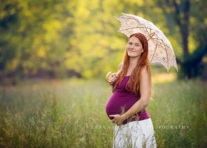 A photo of a pregnant mom taken in Asheville. Mom is holding a beautiful lacy umbrella.