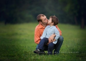 Father and a little son giving each other a kiss.