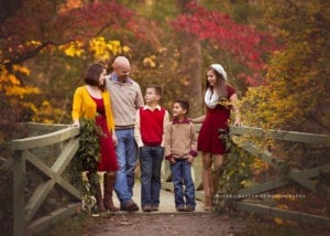 A photo of a family standing on a bridge at the Asheville Botanical Gardens.
