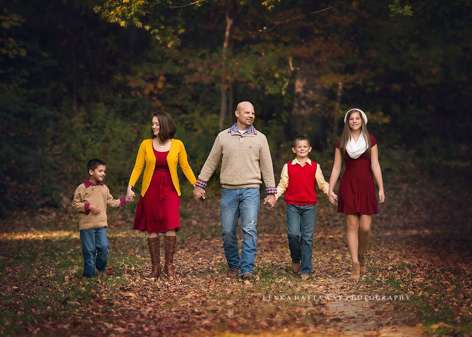 A beautiful colorful image of a family holding hands and walking together.
