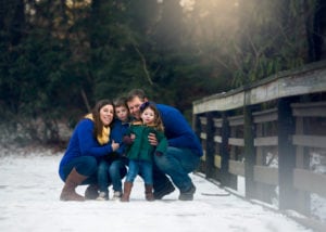 Winter family photo on a bridge at the Botanical Gardens.