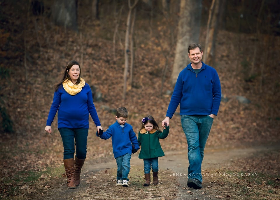 A professional image of a family walking holding hands.