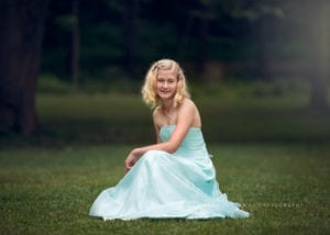 A beautiful professional image of a teen in a lovely blue prom dress.