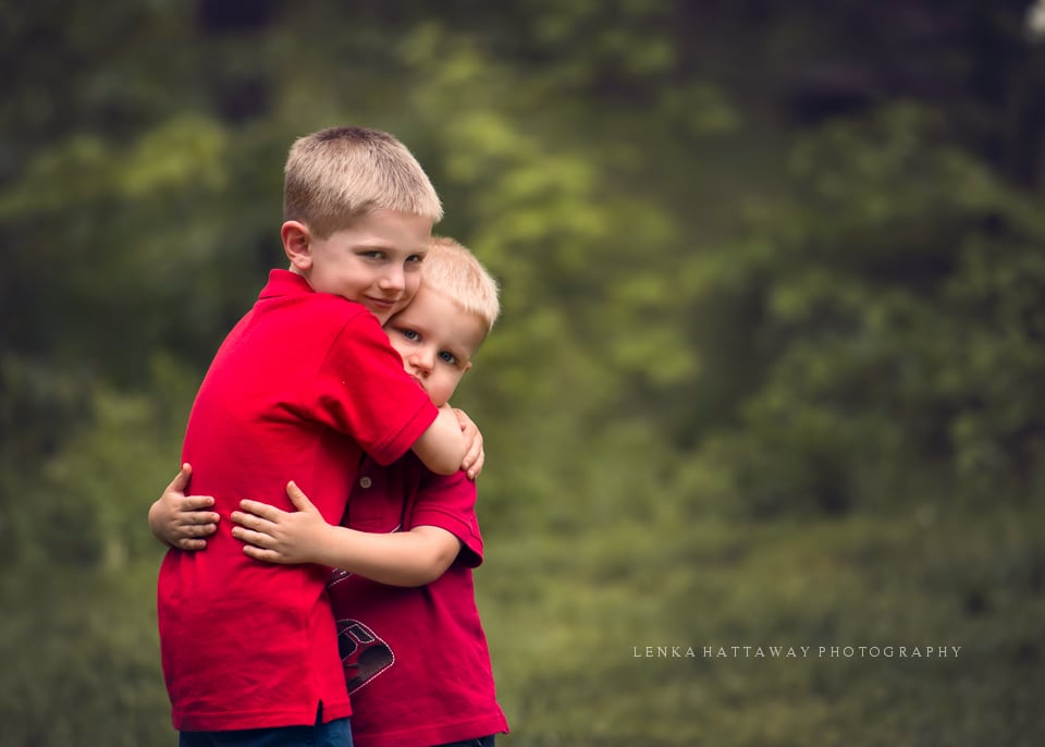 Two brothers hugging each other.