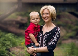 A photo of a mom holding her son taken at the Asheville Botanical Gardens.