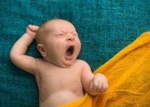 A shot of a newborn baby yawning.
