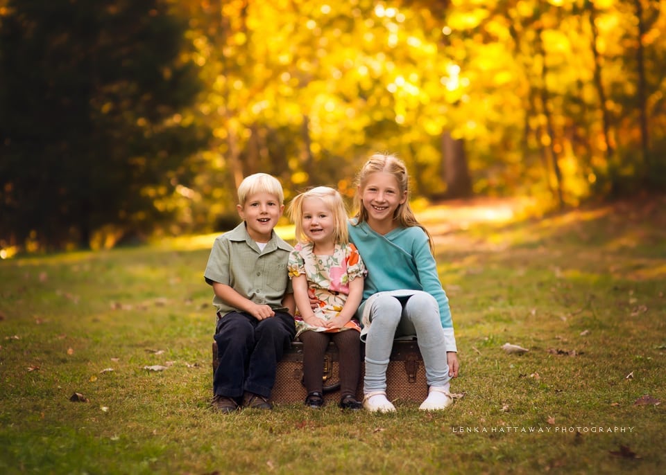 A professional photo of three siblings at the Asheville Botanical Gardens.