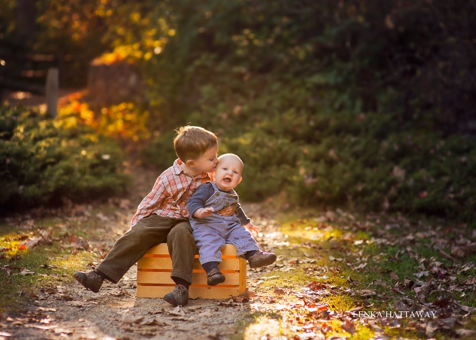 A beutiful photo from the Asheville Botanical Gardens of two siblings sitting together.