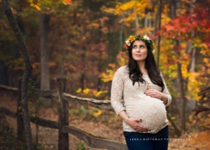 A portrait of a beautiful expecting mom wearing a flower crown.