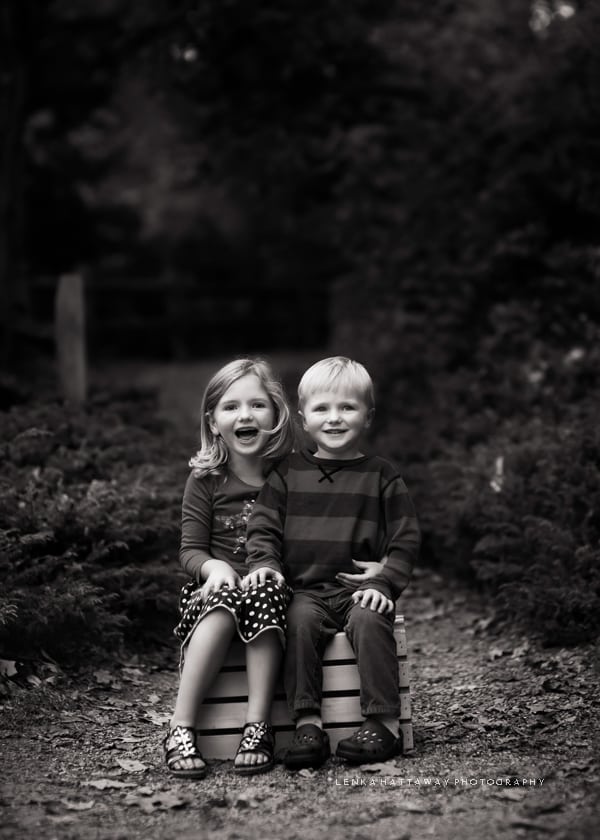 A black and white photo of two little children.