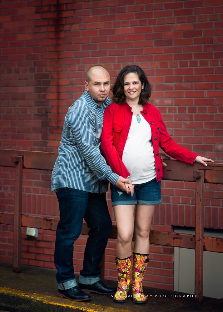 An image of a couple expecting a baby. Photo taken at an urban setting.