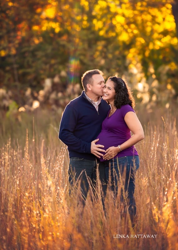 A professional photo from a maternity session of a couple.