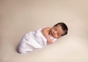 Sleeping newborn wrapped in a blanket.