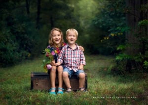 A professional image of siblings sitting down.