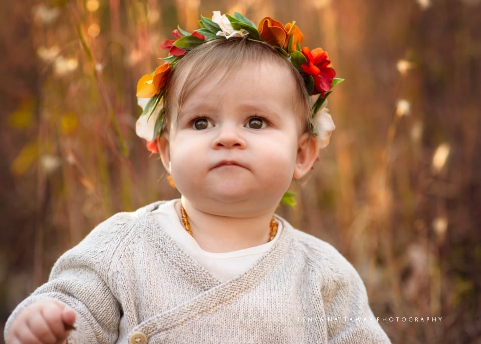 A close up of a baby girl wearing a fall crown. Photo taken at the Asheville Arboretum in the fall.