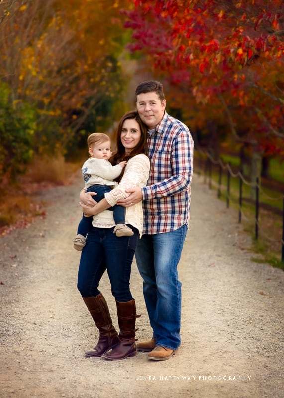 A beautiful fall shot of family. Baby is in mother's arms.