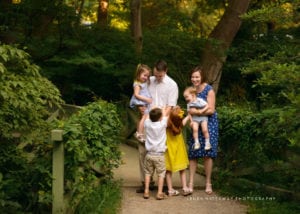 A family of six playing together at the Botanical Gradens, Asheville, NC.