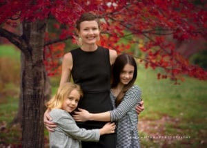 A mom with her two girls holding tight in Asheville, NC.