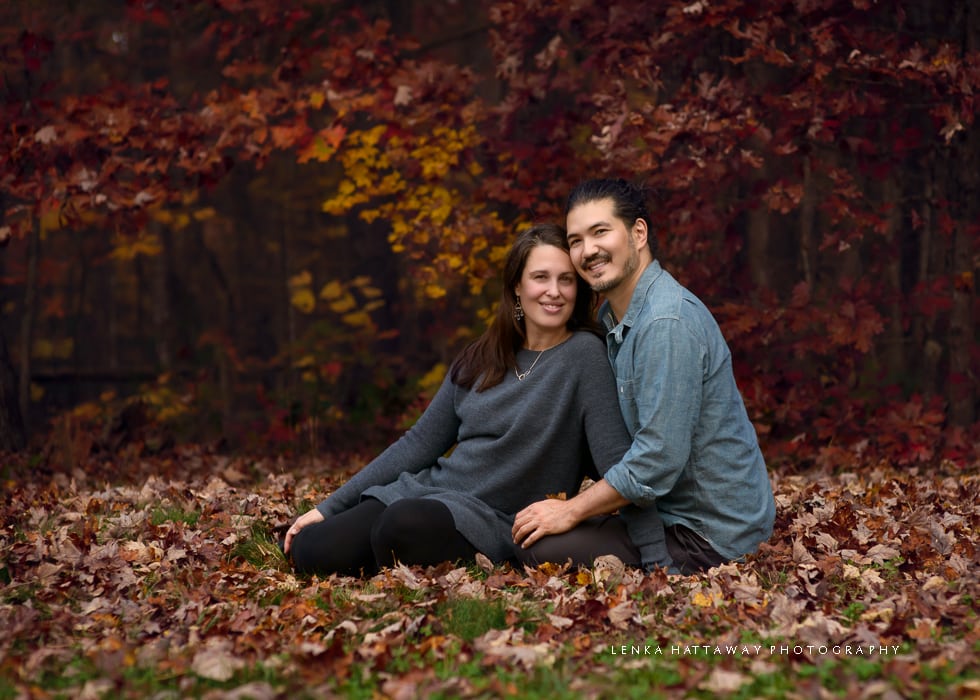 Expecting couple sitting down during their materniy/family session at the Arboretum.