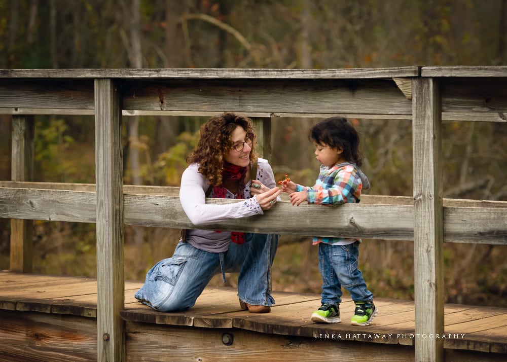 Child photo with his mom on a bridge.