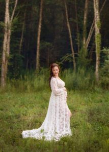 Beautiful maternity photo of a mom-to-be in white dress.