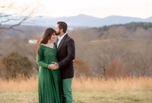 Maternity photography of a couple expecting baby. Mountains in the background