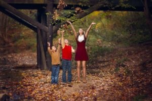 Photo of children throwing leaves.