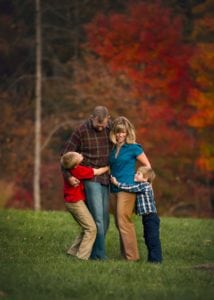 Fall photo of a family hugging together.