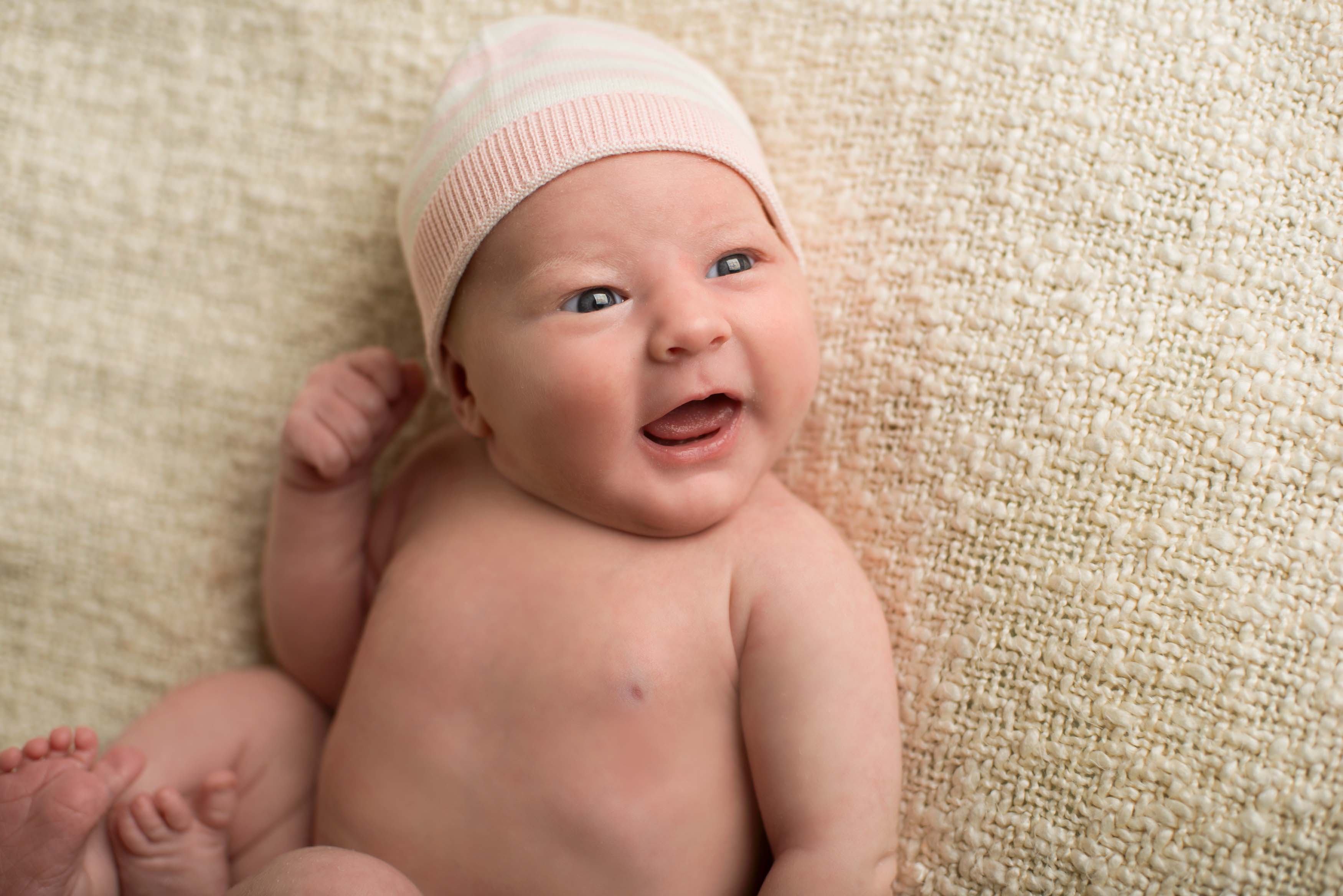 Sweet newborn baby girl with eyes open.