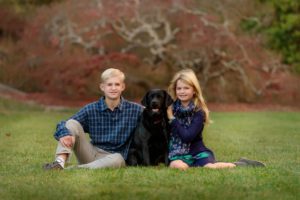 Portrait of brother and sister and their dog.