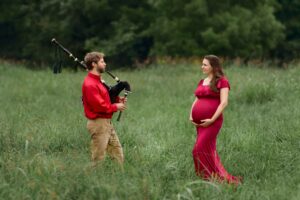 Expecting parents looking at each other, dad-to-be playing bagpipes.
