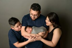 Family holding their newborn baby.