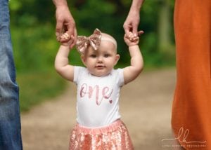 Close-up photo of a baby girl at the Botanical Gardens in Asheville.