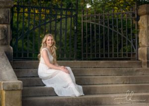 Senior photos at Biltmore. Senior girl sits on steps.