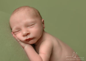 A close up of a sleeping newborn baby.