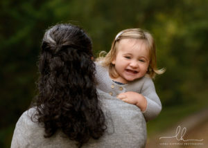 Mom holding her child during a family photo session at the Botanical gardens.