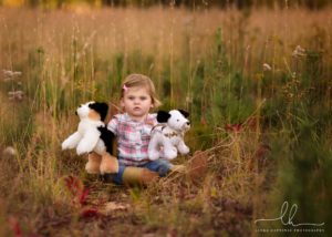 Photo of a baby girl with stuffed animals from Watch me grow baby session.