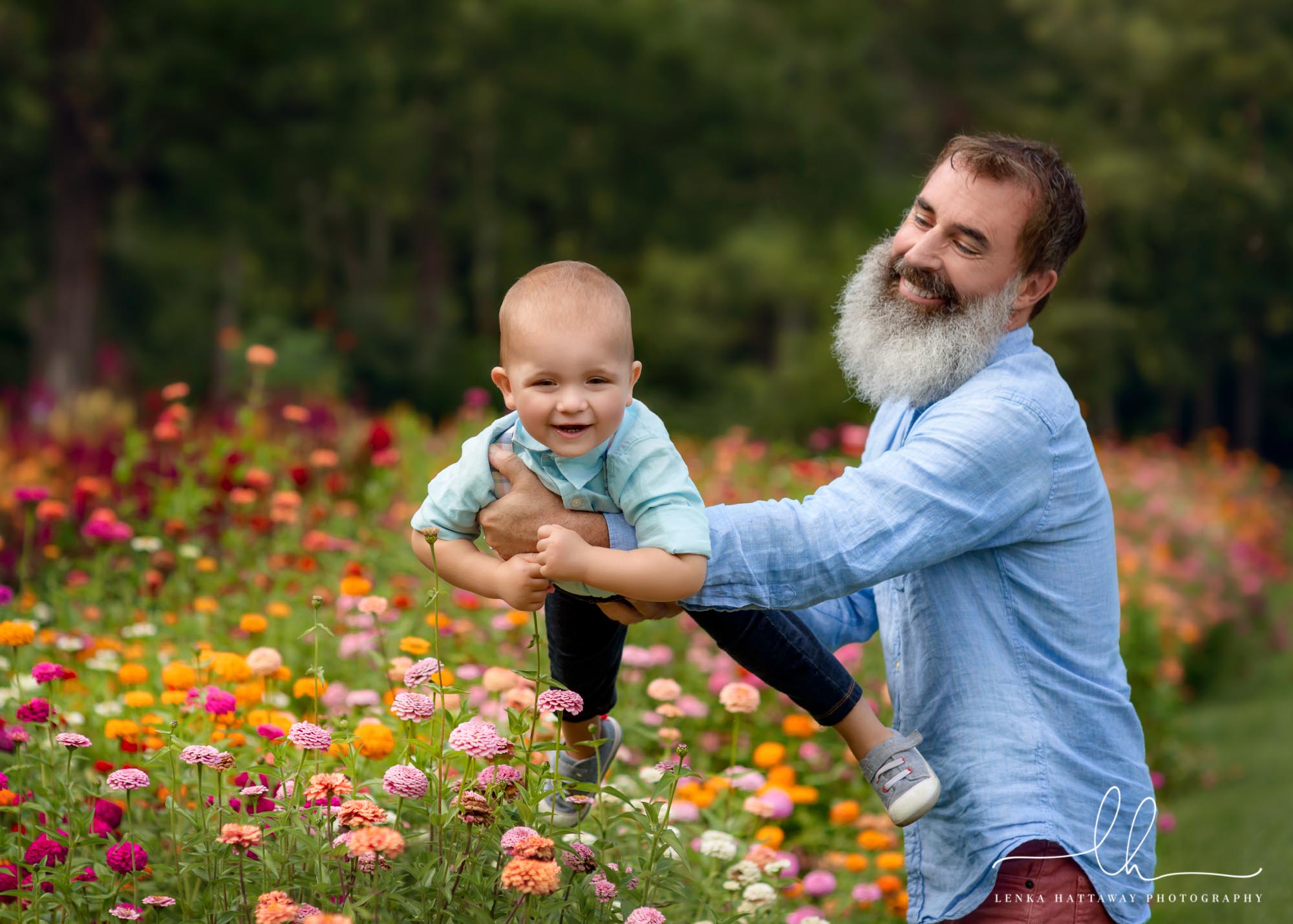 Summer family photos of a dad and son in flowers.