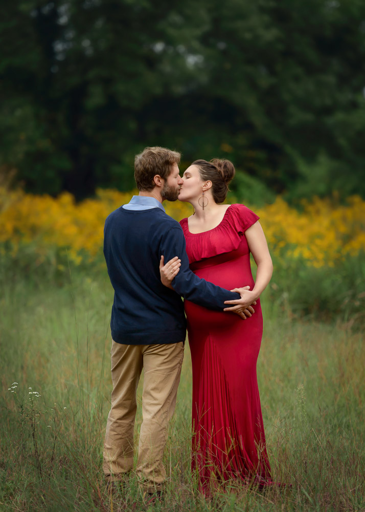 Asheville maternity photo of a couple kissing.