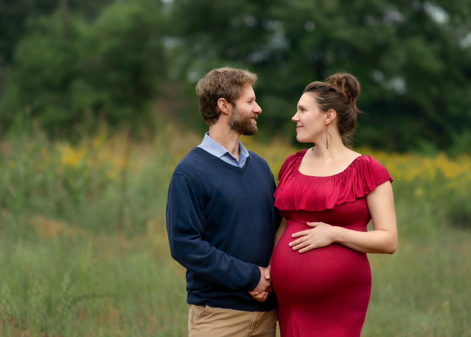 Maternity photography in Asheville of a couple looking at each other.