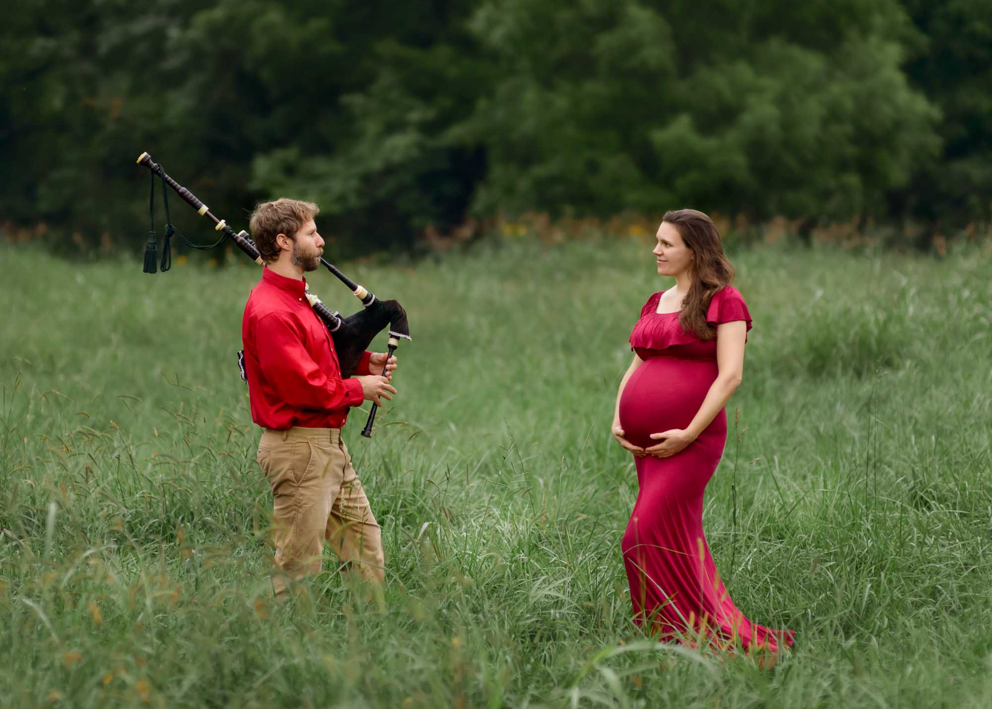 Pregnant mom being serenated by her partner with bagpipes.