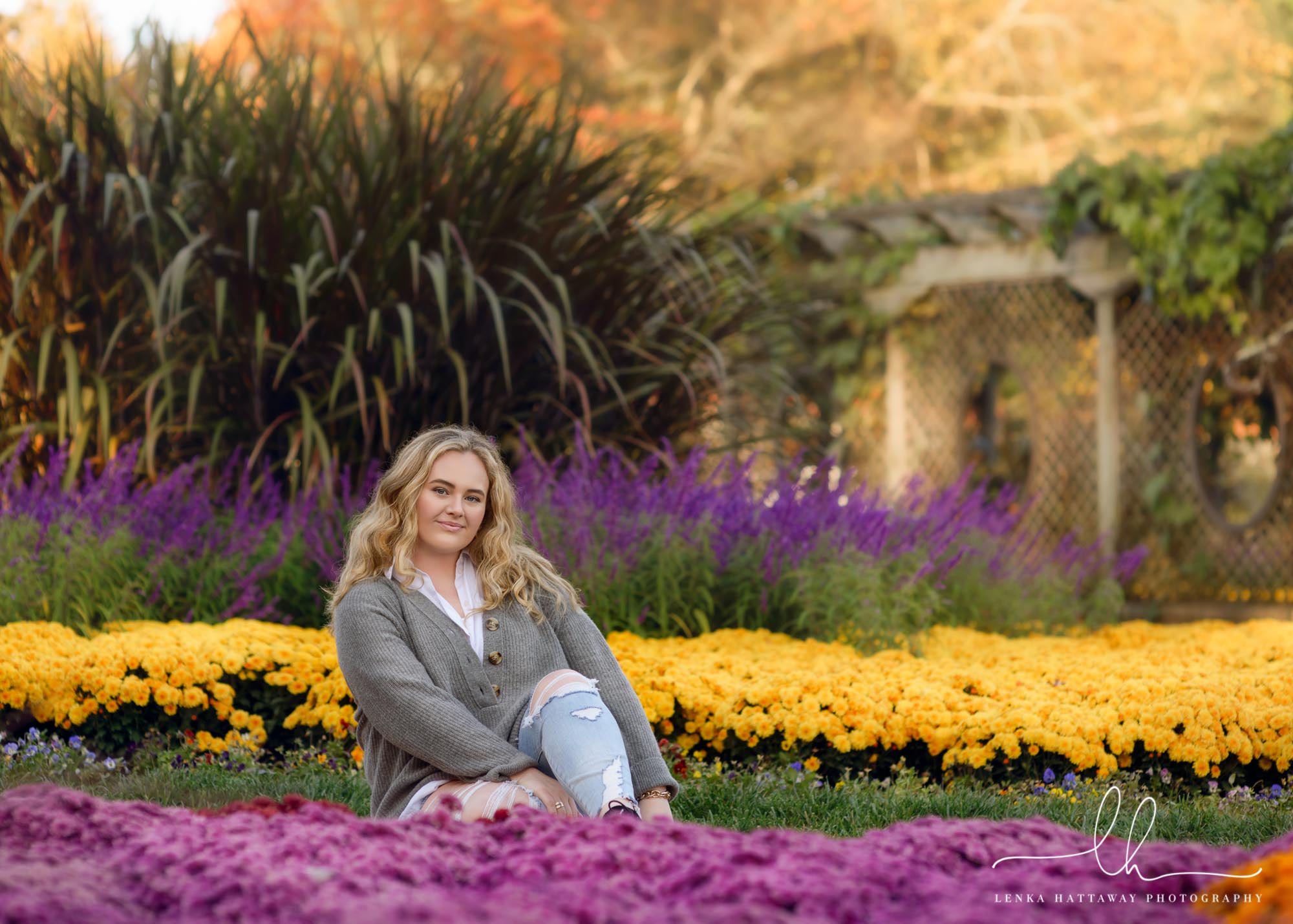 Senior sitting among colorful flowers at the Biltmore Estate Garden.