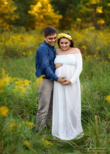 Pregnancy photos in Asheville, NC with yellow flowers.