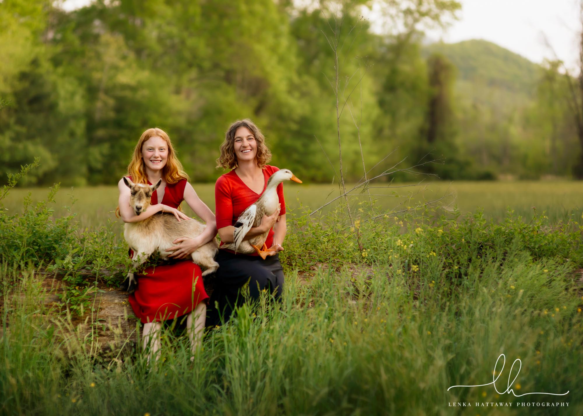 Asheville family photo of mother and daughter with their goat and goose.