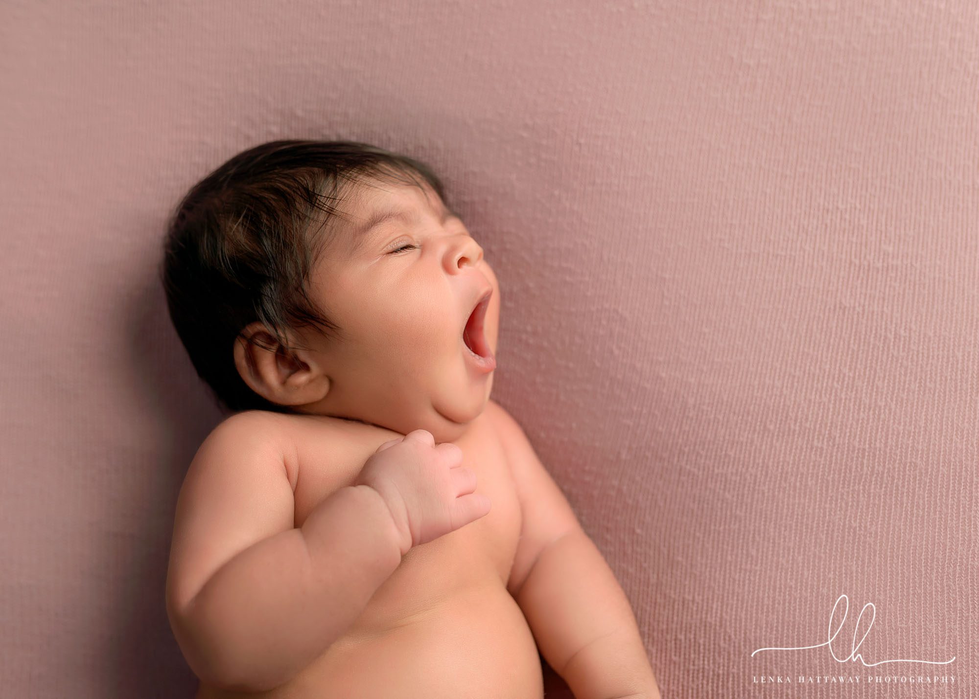 Adorable yawning newborn baby.