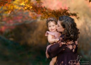 Mom kissing her daughter during a photo session at the Biltmore Estate.