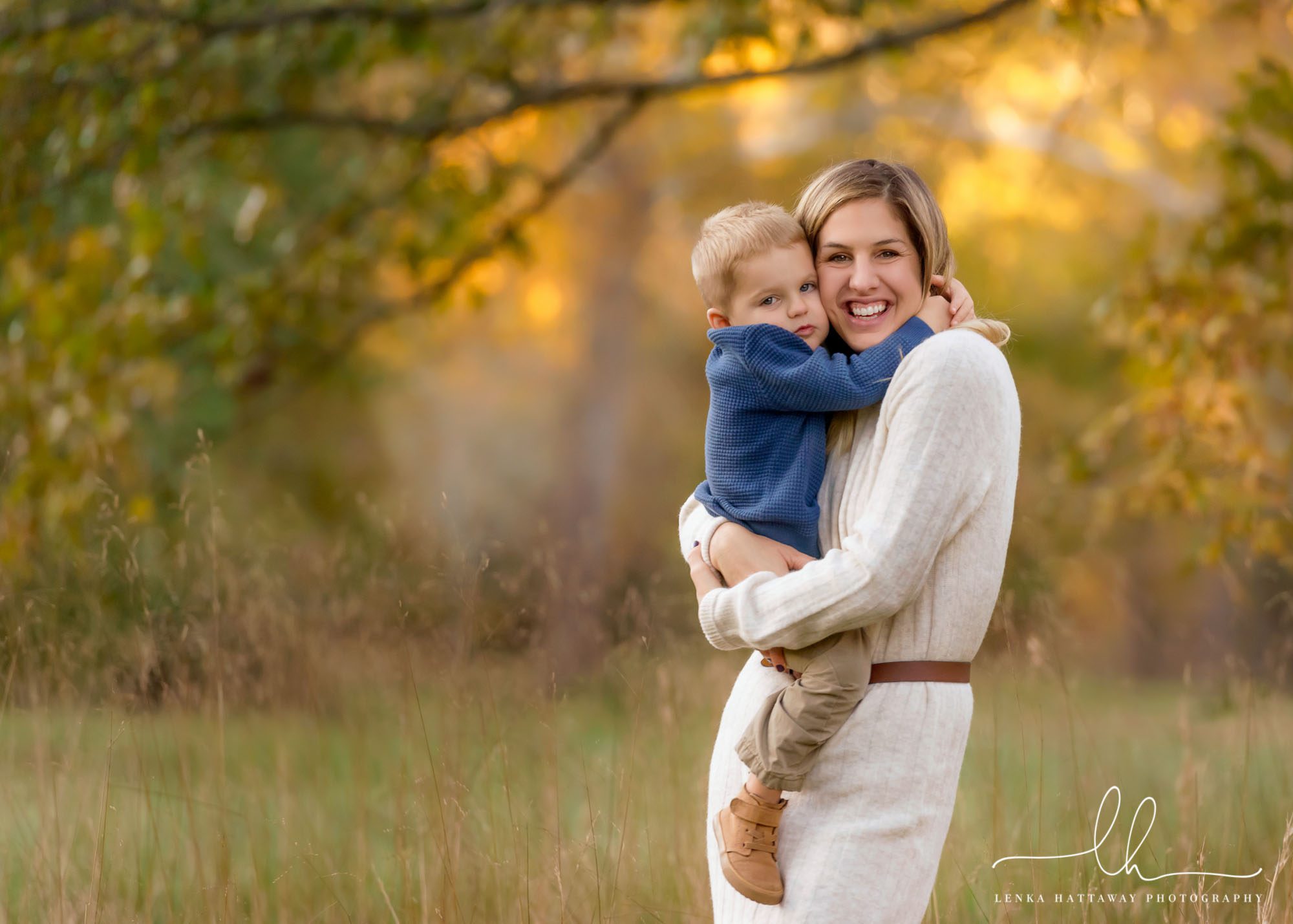Mom and son hugging together during an outdoor family photo session.