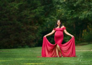 Beautiful pregnancy photo of an expecting mom in red dress.