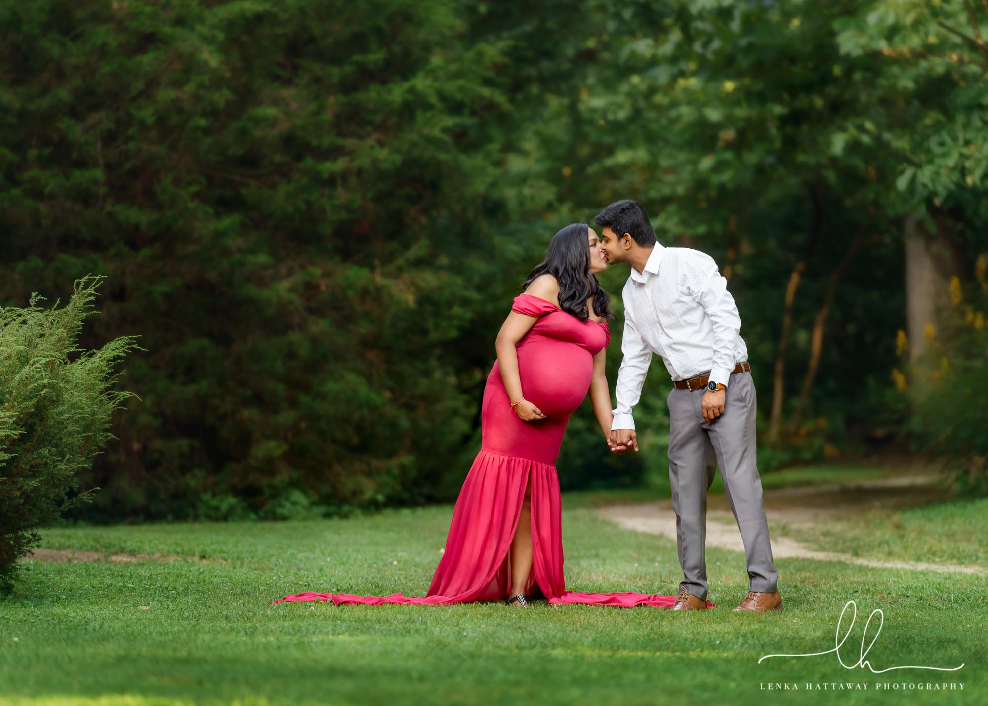 Expecting couple kissing during a maternity photo session.