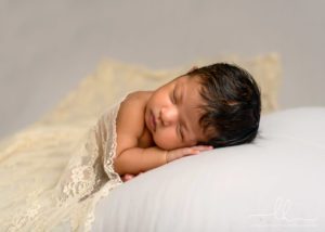 Newborn picture of a baby sleeping.